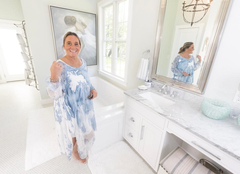 Sally Goodnow stands in the master bathroom of the modern farmhouse she shares with Michael Kell in Plain Township.