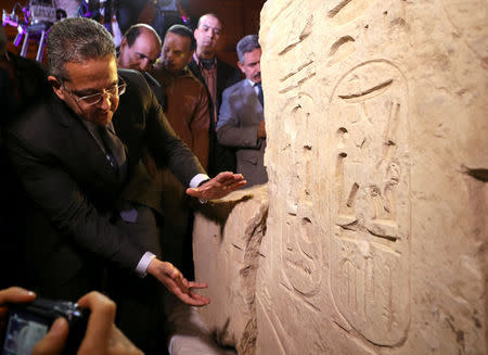 Egyptian Minister of Antiquities Khaled Al-Anani stands beside the collosus explaining new evidence pointing to it depicting Psammetich I in Cairo, Egypt, March 16, 2017. REUTERS/Mohamed Abd El Ghany