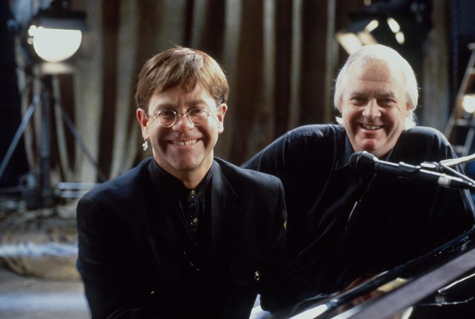 Elton John and Tim Rice sitting at a piano