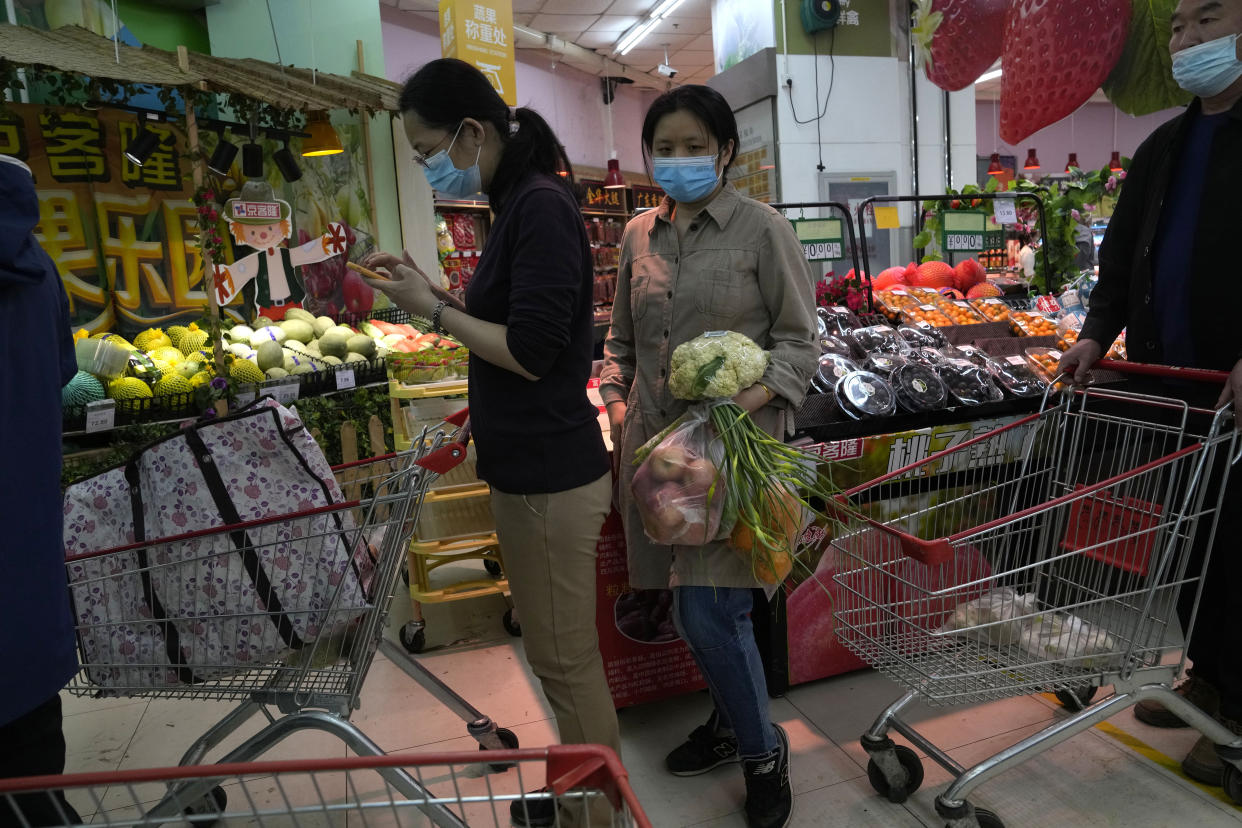 Residents wearing masks shop at a supermarket in the Chaoyang district of Beijing, Monday, April 25, 2022. Mass testing started Monday in Chaoyang district, home to more than 3 million people in the Chinese capital, following a fresh COVID-19 outbreak. (AP Photo/Ng Han Guan)