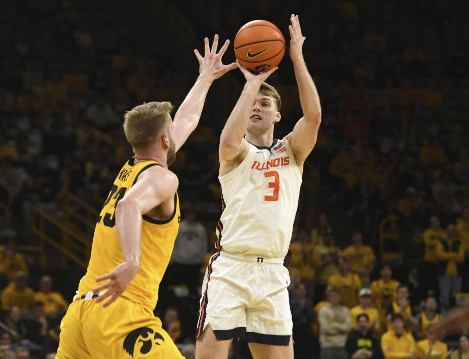 Illinois guard/forward Marcus Domask (3) takes a 3-point shot over Iowa forward Ben Krikke (23) during the first half of an NCAA college basketball game, Sunday, March 10, 2024, in Iowa City, Iowa. (AP Photo/Cliff Jette)