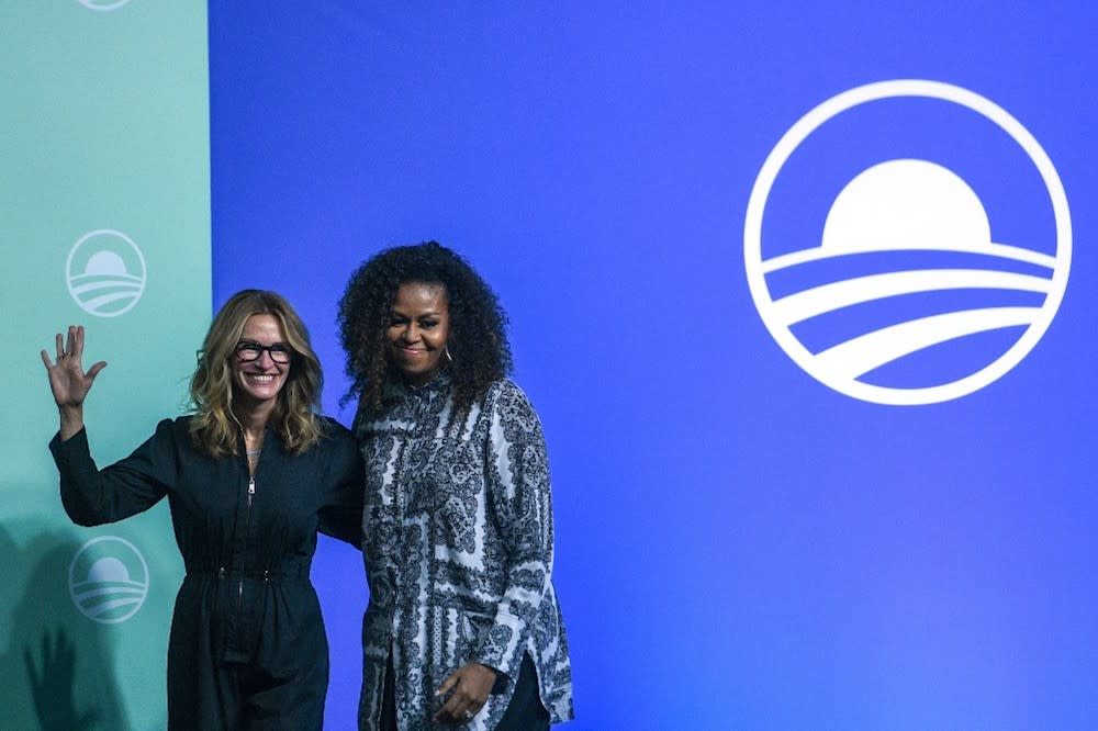 Former US first lady Michelle Obama and US actress Julia Roberts gesture as they arrive to attend an event for the Obama Foundation in Kuala Lumpur December 12, 2019. — AFP pic