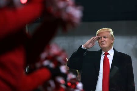 U.S. President Donald Trump salutes participants during the inaugural parade in Washington, January 20, 2017. Donald Trump was sworn in earlier as the 45th President of the United States. REUTERS/Carlos Barria