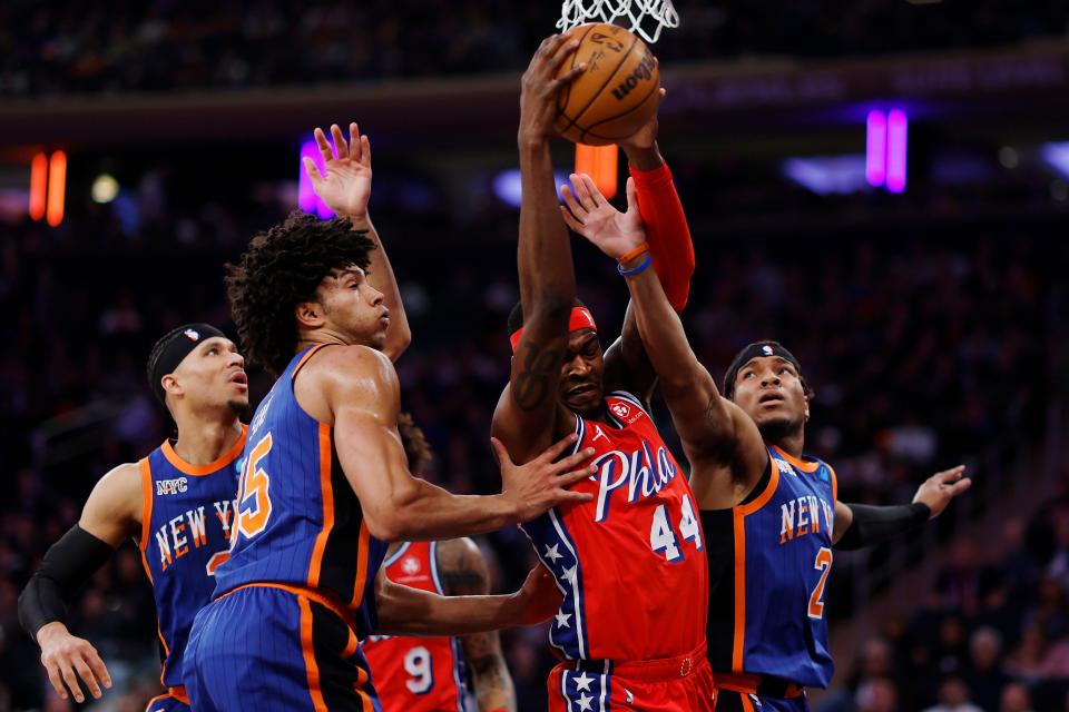 NEW YORK, NEW YORK - MARCH 10: Paul Reed #44 of the Philadelphia 76ers grabs a rebound as Jericho Sims #45, Josh Hart #3, and Miles McBride #2 of the New York Knicks defend during the first half at Madison Square Garden on March 10, 2024 in New York City. NOTE TO USER: User expressly acknowledges and agrees that, by downloading and or using this photograph, User is consenting to the terms and conditions of the Getty Images License Agreement. (Photo by Sarah Stier/Getty Images)