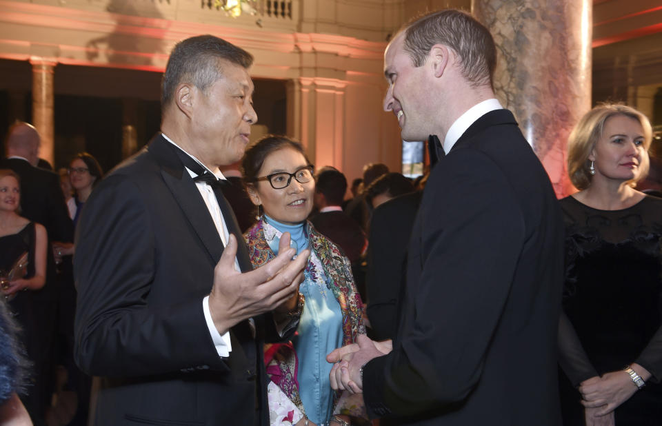 FILE - In this Nov. 30, 2016 file photo, Chinese Ambassador to the United Kingdom, Liu Xiaoming, left, speaks with Britain's Prince William, Duke of Cambridge during the Tusk Conservation Awards at Victoria and Albert Museum in London. Much of the popular support Liu, who recently stepped down as China’s ambassador to the U.K., and his colleagues seem to enjoy on Twitter has, in fact, been manufactured, an AP and Oxford Internet Institute investigation found. More than one in ten retweets of Chinese diplomats came from accounts Twitter suspended for breaking platform rules, which bar manipulation. (Stuart C. Wilson/Pool Photo via AP, File)