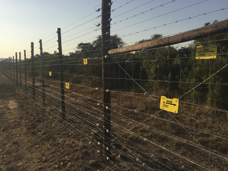 In this July 7, 2020 photo supplied by Wildlife ACT a view of a "smart fence" erected in the I KwaZulu-Natal province's Hluhluwe-iMfolozi park, which alerts park rangers when intruders try to enter the park. South Africa’s anti-COVID-19 lockdown is credited with helping to achieve a dramatic drop in rhino killings, but as the country opens up experts warn there is a risk of a resurgence of poaching of one of Earth’s most endangered mammals. Redoubled efforts are critical to prevent a resurgence of killings of the country’s rhinoceros, South African officials and wildlife activists say, as World Rhino Day is marked Tuesday, Sept. 22, 2020. (Mark Gerrard/Wildlife ACT via AP)