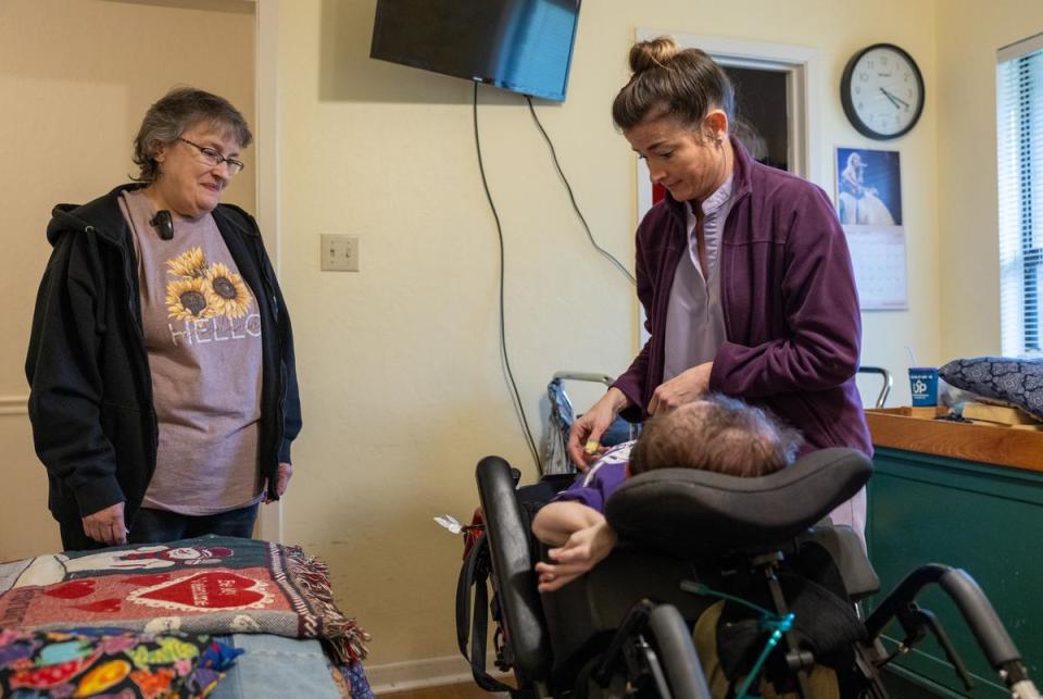 Debbie watches as RN Brooke Miles Jackson get ready to help Daniel stretch out following UP on Feb. 29, 2024.