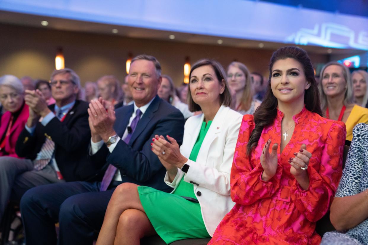 Bob Vander Plaats, Governor Kim Reynolds, and Casey DeSantis applaud as Republican presidential candidate and Florida Gov. Ron DeSantis talks with moderator Tucker Carlson during the Family Leadership Summit in Des Moines, Friday, July 14, 2023. 