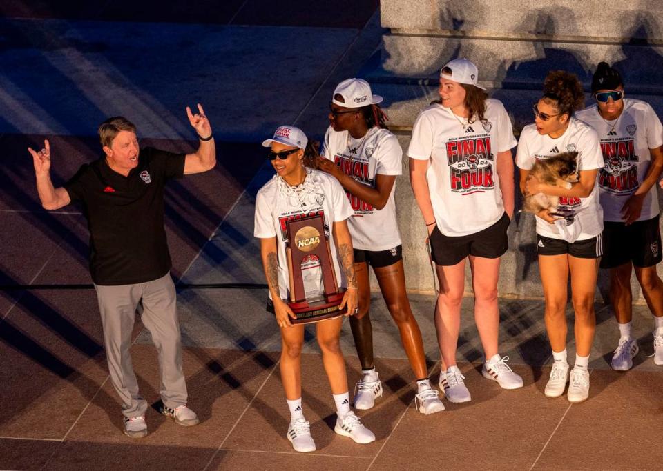 NC State’s women’s basketball players and head coach Wes Moore celebrate their Final Four run at the Memorial Belltower on Monday, April 15, 2024. Travis Long/tlong@newsobserver.com