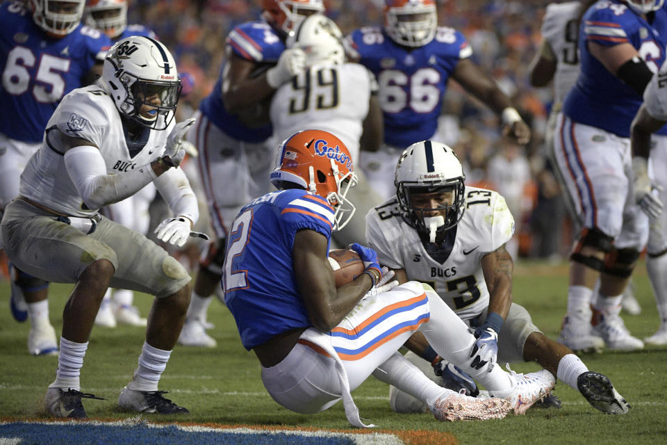 Florida wide receiver Van Jefferson (12) catches a pass in the end zone for a 6-yard touchdown in front of Charleston Southern defensive back Shadarius Hopkins (6) and defensive back James Allen (13) during the first half of an NCAA college football game, Saturday, Sept. 1, 2018, in Gainesville, Fla. (AP Photo/Phelan M. Ebenhack)