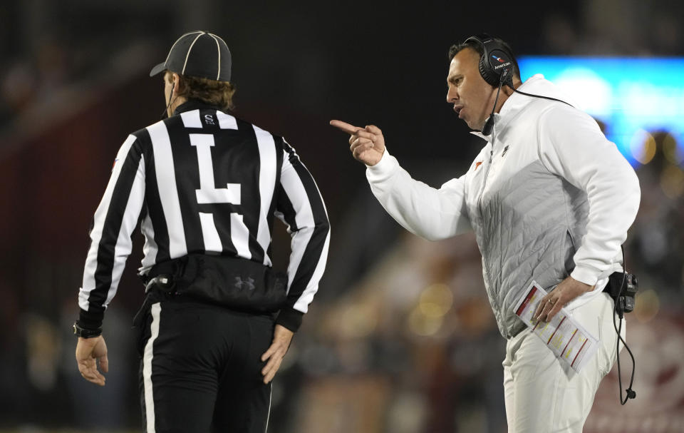 Texas head coach Steve Sarkisian, right, disputes a timeout with an official, left, during the first half of an NCAA college football game against Iowa State, Saturday, Nov. 18, 2023, in Ames, Iowa. (AP Photo/Matthew Putney)