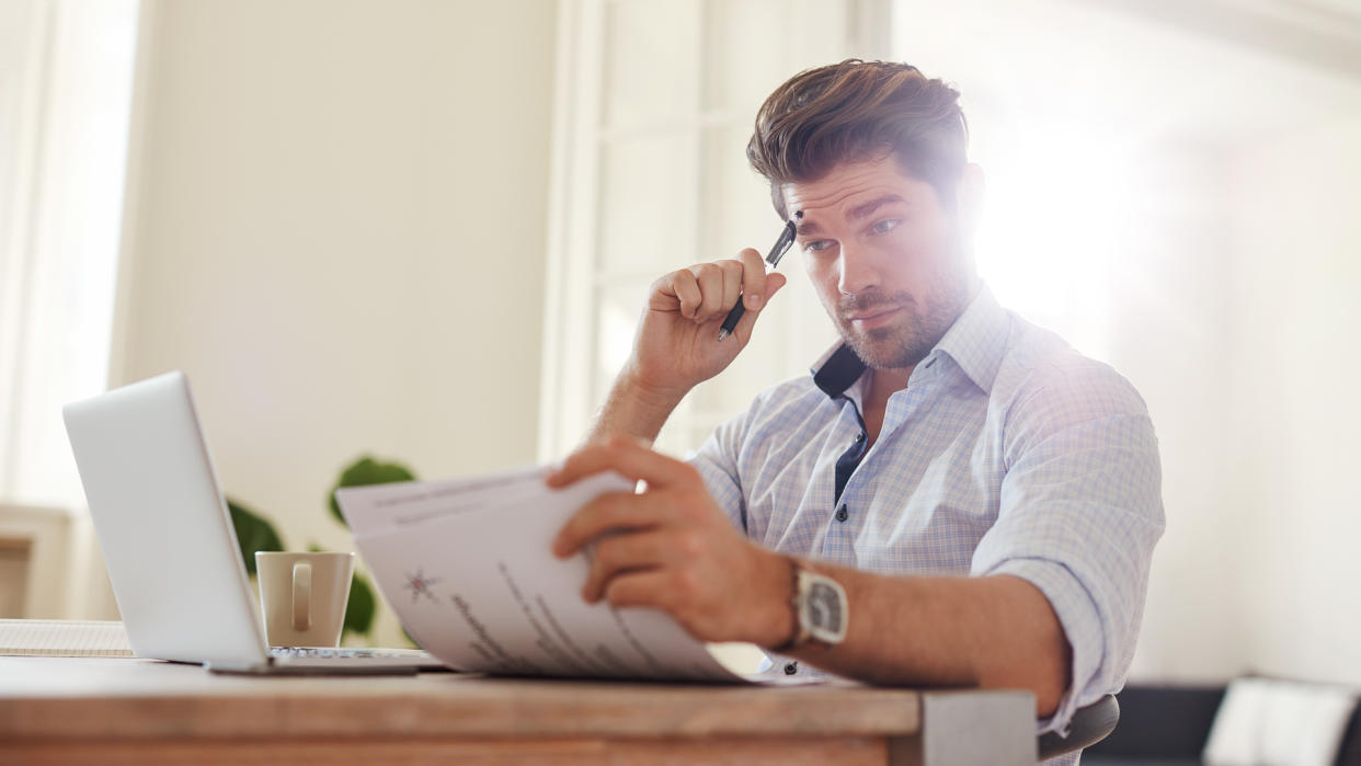 man sitting at table thinking of his future