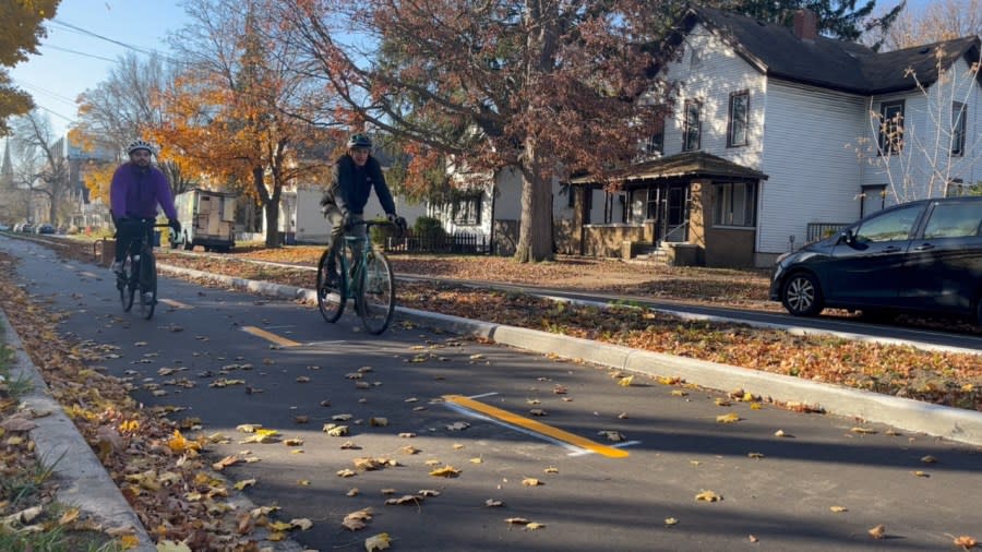 Nate DeHaan and Donovan Tesin with the Greater Grand Rapids Bicycle Coalition bike the new protected bike path along Turner Avenue. (Nov. 15, 2023)