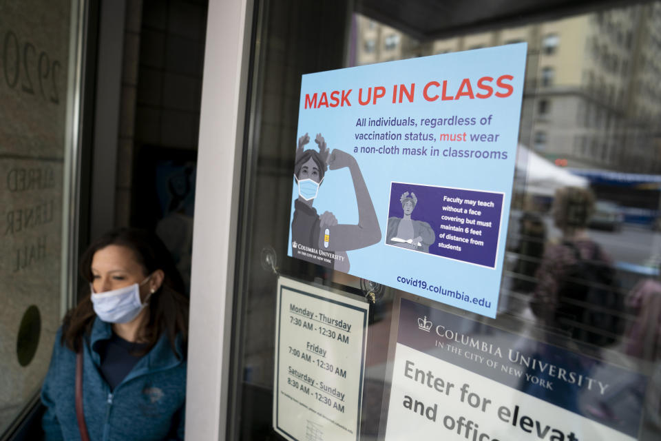 Signs indicating that protective face masks must be worn in classrooms are displayed outside lecture halls at Columbia University, Thursday, April 21, 2022, in the Manhattan borough of New York. (AP Photo/John Minchillo)