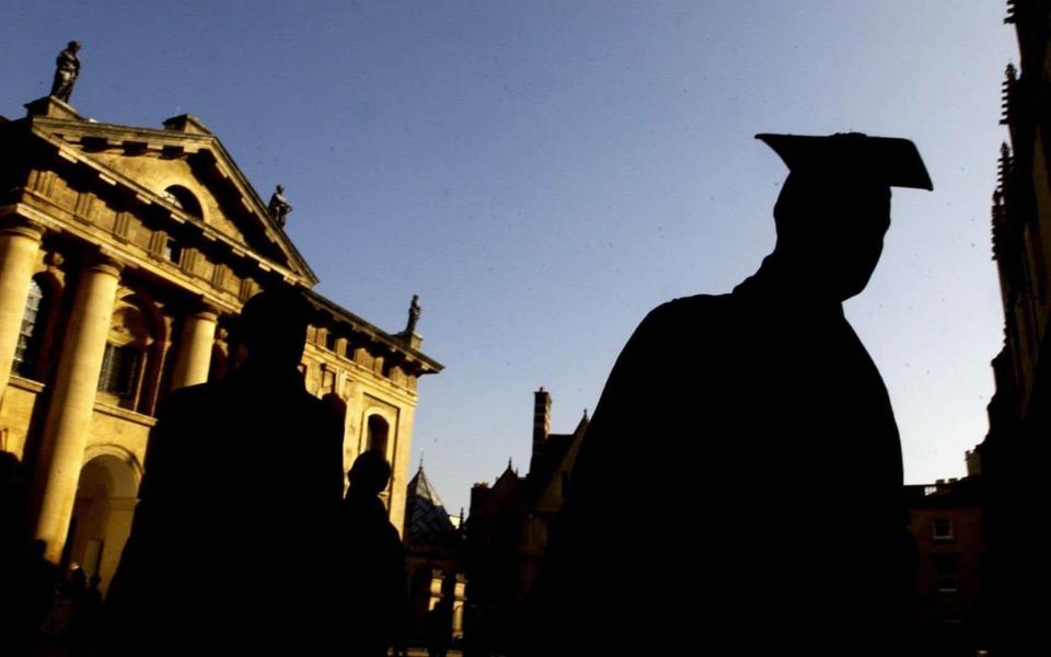 Graduates queue in the quadrangle of the Sheldonian Theatre in Oxford - PA/CHRIS YOUNG