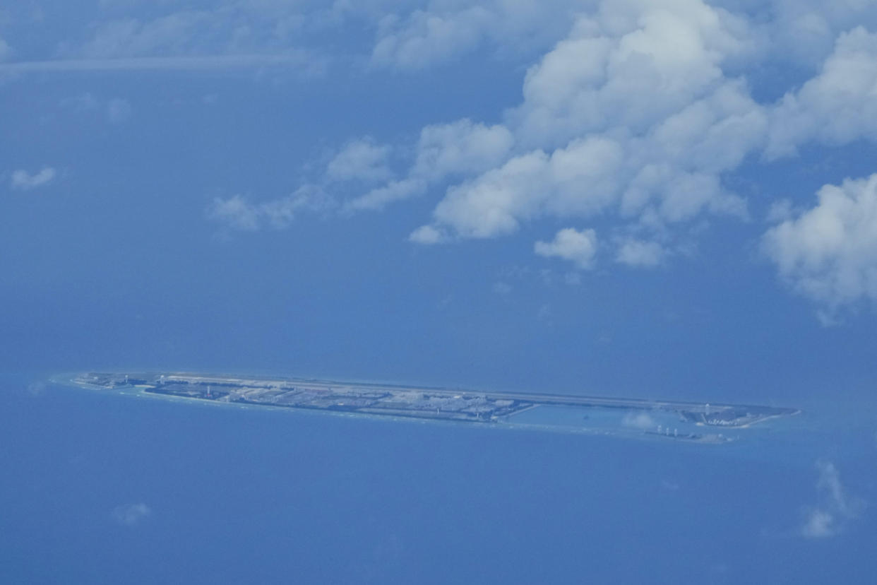 Chinese structures and buildings at the man-made island on Fiery Cross Reef at the Spratlys group of islands in the South China Sea are seen on Sunday March 20, 2022. China has fully militarized at least three of several islands it built in the disputed South China Sea, arming them with anti-ship and anti-aircraft missile systems, laser and jamming equipment and fighter jets in an increasingly aggressive move that threatens all nations operating nearby, a top U.S. military commander said Sunday. (AP Photo/Aaron Favila)