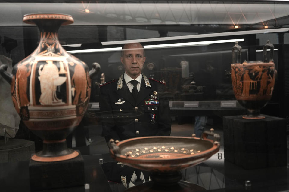 General Roberto Riccardi, Head of Carabinieri unit for the Protection of Cultural Heritage looks at archaeological artifacts displayed in the new "Museum of Rescued Art" in Rome, Wednesday, June 15, 2022. Italy has been so successful in regaining ancient artworks and artifacts illegally exported from the country that it has now created a museum just for them, the Museum of Rescued Art, inaugurated on Wednesday in the cavernous Octagonal Hall of the ancient Baths of Diocletian. (AP Photo/Alessandra Tarantino)