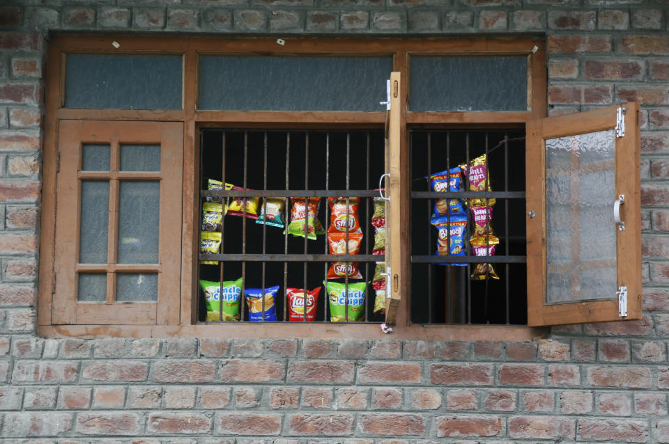 Snacks are displayed for sale by the window of a residential building as shops remain closed in Srinagar, Indian controlled Kashmir, Wednesday, Aug. 28, 2019. India's government, led by the Hindu nationalist Bharatiya Janata Party, imposed a security lockdown and communications blackout in Muslim-majority Kashmir to avoid a violent reaction to the Aug. 5 decision to downgrade the region's autonomy. The restrictions have been eased slowly, with some businesses reopening, some landline phone service restored and some grade schools holding classes again, though student and teacher attendance has been sparse. (AP Photo/Mukhtar Khan)