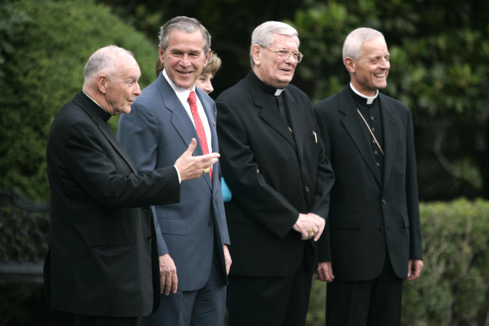 CORRECTS THE PUBLISHED DATE OF THE GRAND JURY REPORT TO AUG. 14, NOT 15 - FILE - In this Tuesday, July 18, 2006 file photo, President Bush, second from left, smiles at Cardinal Theodore McCarrick, left, during a photo opportunity on the South Lawn of the White House in Washington. From left is McCarrick, Bush, first lady Laura Bush, Papal Nuncio Pietro Sambi, and Archbishop of Washington Donald W. Wuerl. On Tuesday, Aug. 14, 2018, a Pennsylvania grand jury accused Cardinal Wuerl of helping to protect abusive priests when he was Pittsburgh's bishop. (AP Photo/Evan Vucci)
