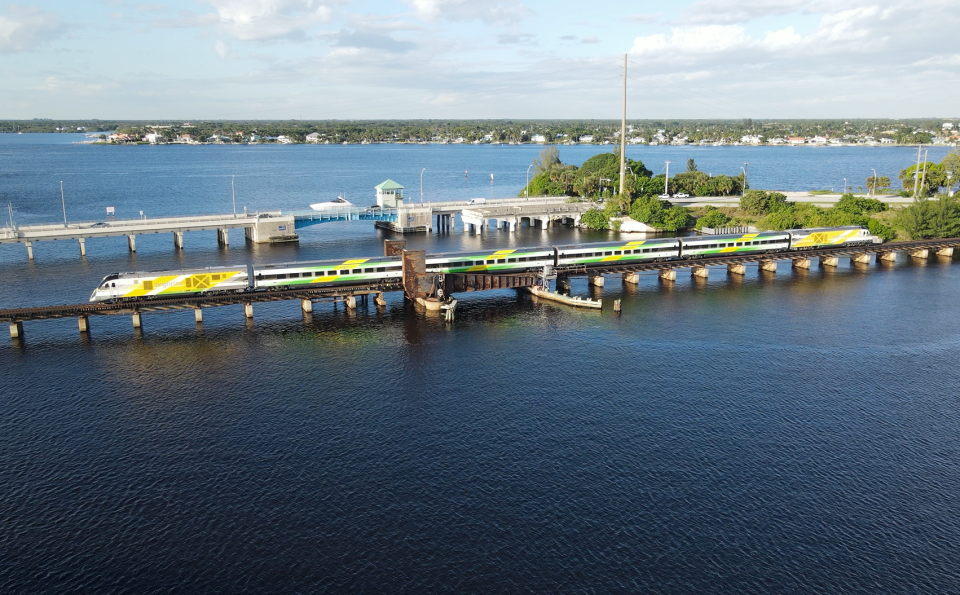 A Brightline train is seen crossing the St. Lucie River railroad bridge in Stuart, Fla., in February 2023.