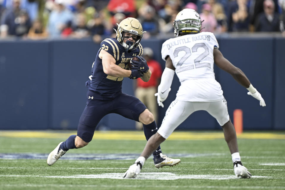 Navy running back Eli Heidenreich runs the ball against Air Force defensive back Jerome Gaillard Jr. (22) during the second half of an NCAA college football game, Saturday, Oct. 21, 2023, in Annapolis. (AP Photo/Terrance Williams)