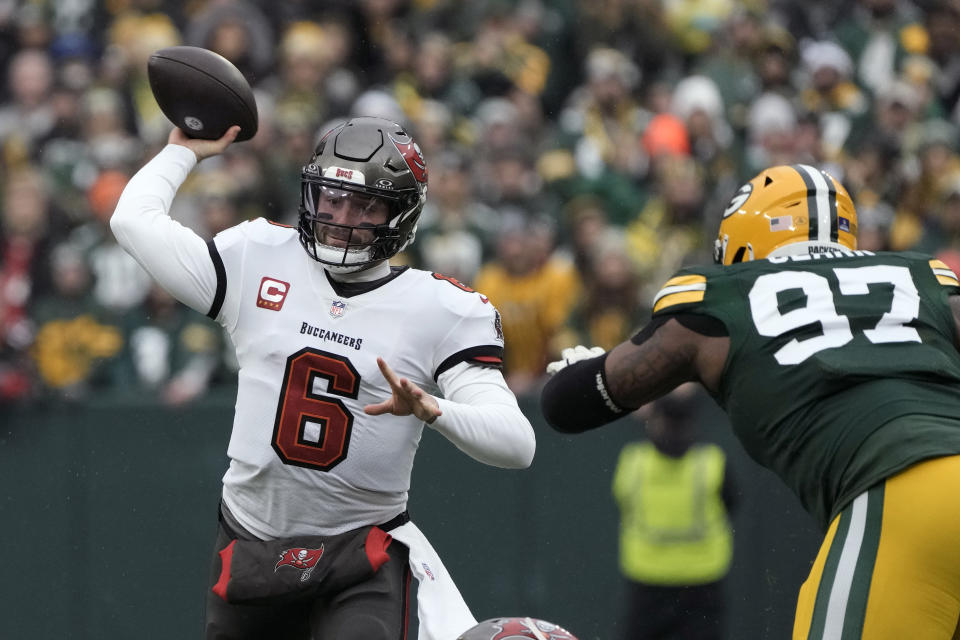 Tampa Bay Buccaneers quarterback Baker Mayfield (6) throws a pass as he is pressured by Green Bay Packers defensive tackle Kenny Clark (97) during the first half of an NFL football game, Sunday, Dec. 17, 2023, in Green Bay, Wis. (AP Photo/Morry Gash)