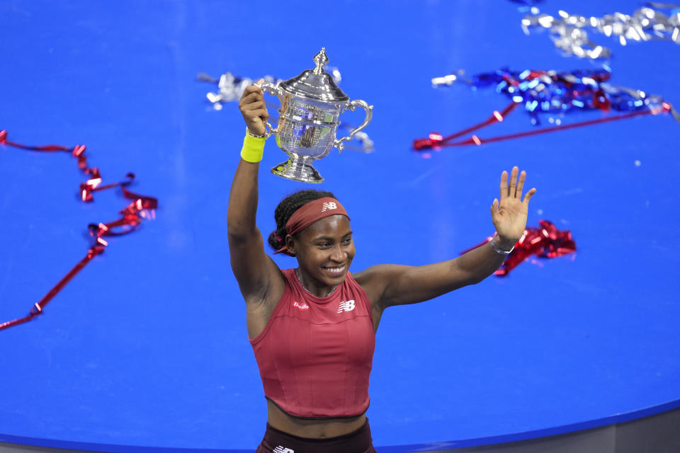 Coco Gauff, of the United States, poses for photographs after defeating Aryna Sabalenka, of Belarus, at the women's singles final of the U.S. Open tennis championships, Saturday, Sept. 9, 2023, in New York. (AP Photo/John Minchillo)