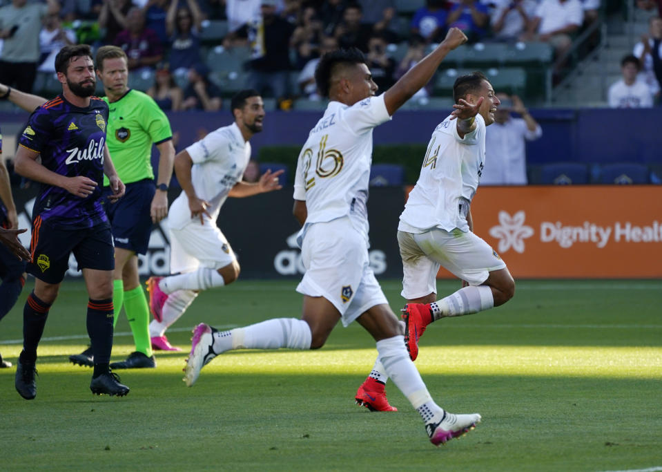 LA Galaxy forward Javier Hernandez, right, and midfielder Efrain Alvarez, second from right, celebrate a goal by midfielder Sacha Kljestan during the first half of a Major League Soccer match against the Seattle Sounders Saturday, June 19, 2021, in Carson, Calif. (AP Photo/Mark J. Terrill)