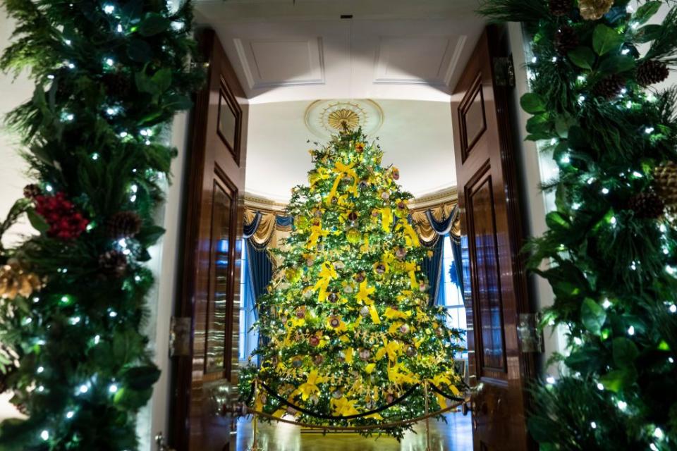 <p>For the Trumps's last Christmas in the White House, the First Lady chose the theme "America the Beautiful." The decor featured pops of color, including yellow bows on the official tree and red ornaments on trees lining the hallways.</p>