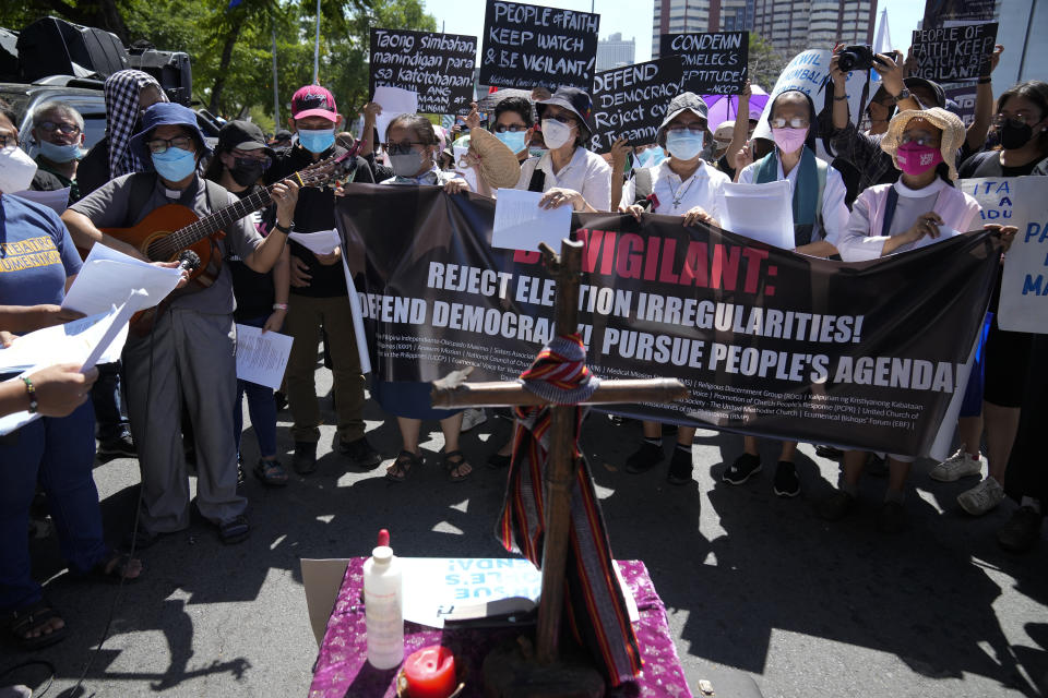 Protesters pray during a rally against presidential frontrunner Ferdinand "Bongbong" Marcos and running mate Sara Duterte, daughter of the current president, during a rally in Pasay, Philippines on Friday, May 13, 2022. Allies of the Philippines' presumptive next president, Ferdinand "Bongbong" Marcos Jr., appear set to strongly dominate both chambers of Congress, further alarming activists after the late dictator's son scored an apparent election victory that will restore his family to the seat of power. (AP Photo/Aaron Favila)