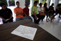 Mexican immigrants who have been unable to obtain work permits after living and working for years or even decades in the US., meet with activist Nora Sandigo and journalists, Tuesday, Nov. 7, 2023, in Miami. A message published by the Nora Sandigo Children's Foundation reads in Spanish, "Our Lady of Guadalupe, Queen of Mexico and Empress of America, advocates for us migrants, so that President Biden will meet with our representative and support us legally by signing the executive order." (AP Photo/Rebecca Blackwell)