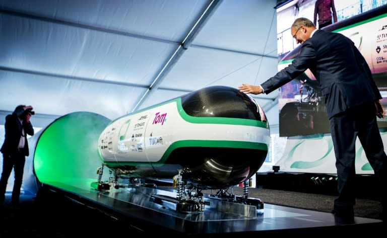 Dutch Minister for economic affairs Henk Kamp checks out the prototype during the unveiling of the Hyper Loop capsule from the Delft University of Technology in Delft, in June 2016
