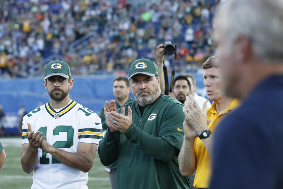 CANTON, OH - AUGUST 07: Aaron Rodgers #12 and head coach Mike McCarthy of the Green Bay Packers acknowledge Hall of Famer Brett Favre as he is introduced after the NFL Hall of Fame Game against the Indianapolis Colts was cancelled due to poor field conditions at Tom Benson Hall of Fame Stadium on August 7, 2016 in Canton, Ohio. (Photo by Joe Robbins/Getty Images)