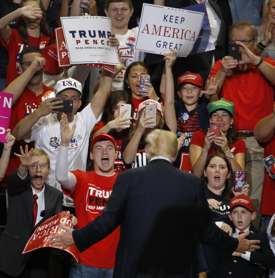 President Donald Trump greets the crowd during a campaign rally Friday, Sept. 21, 2018, in Springfield, Mo. (AP Photo/Charlie Riedel)