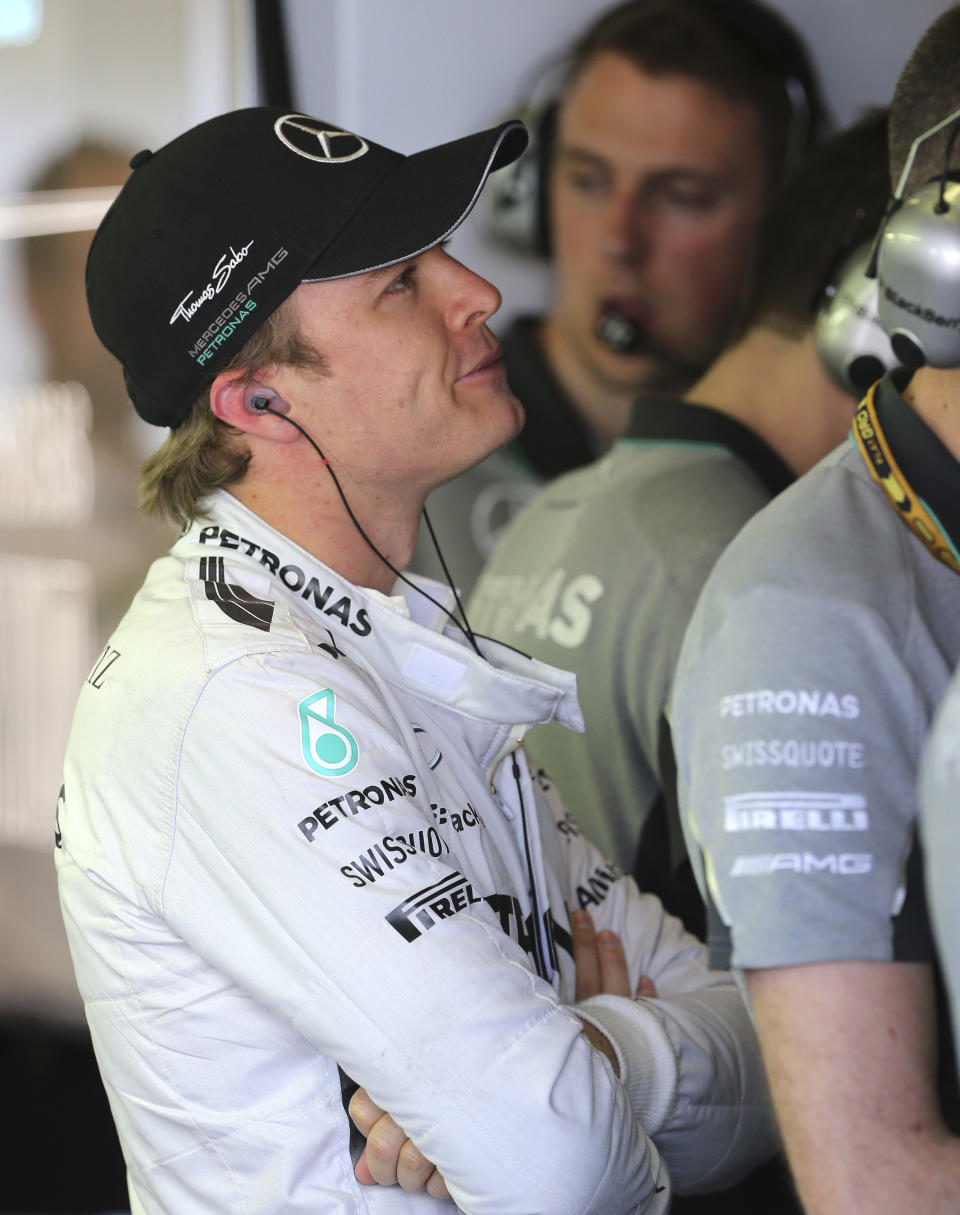 Mercedes driver Nico Rosberg of Germany watches monitors in his garage during the first practice session for the Australian Formula One Grand Prix at Albert Park in Melbourne, Australia, Friday, March 14, 2014. (AP Photo/Rob Griffith)