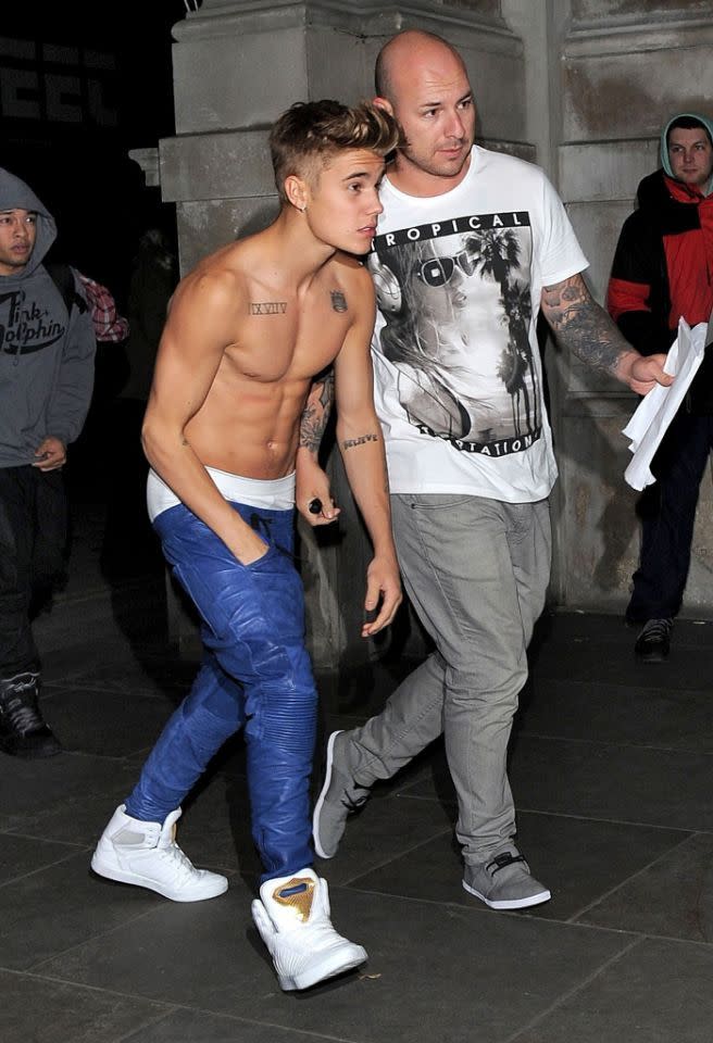 Look closely and you’ll see a gentleman with a winter coat on in the background of this shot. Not the Biebs! He was happily displaying those rock-hard abs… and undies too. (Photo: FameFlynet)