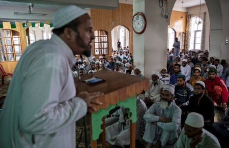 The Wider Image: Barricades and books in restive Kashmir neighbourhood