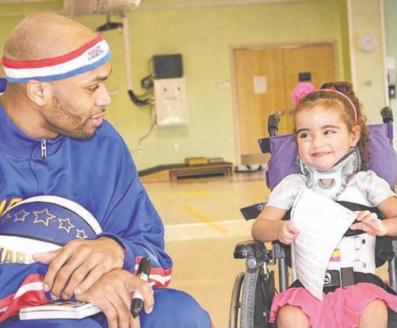 Harlem Globetrotter Hawk Thomas put a smile on the face of Lauren Cavalcanti, 4, of Newark, during a visit at PSE&G Children’s Specialized Hospital in New Brunswick on Monday, Feb. 10, 2014.