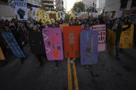 Black Lives Matter protesters march through downtown Oakland on Saturday, July 25, 2020, in Oakland, Calif. Protesters in California set fire to a courthouse, damaged a police station and assaulted officers after a peaceful demonstration intensified late Saturday, Oakland police said. (AP Photo/ Christian Monterrosa)