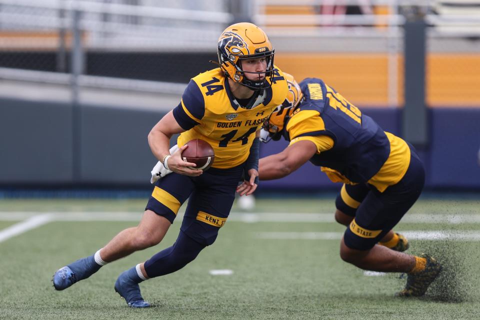 Kent State quarterback Tommy Ulatowski tries to avoid a defender during the spring game this past April 29.