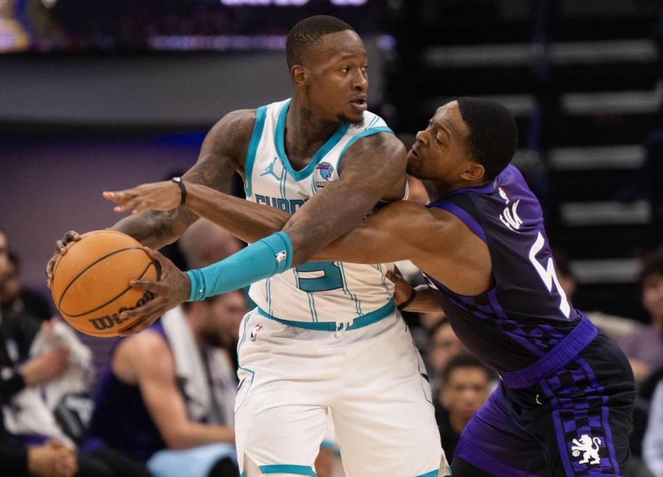 Charlotte Hornets guard Terry Rozier (3) is defended by Sacramento Kings guard De’Aaron Fox (5) during an NBA game on Tuesday at Golden 1 Center.