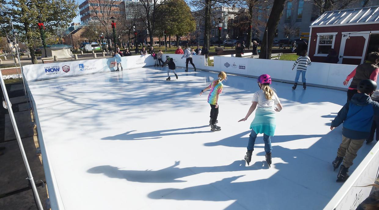 People skate in east Perry Square in Erie on Nov. 26, 2022. The Erie Downtown Partnership installed the rink, which can expand if needed, with primary sponsorship from Erie Insurance.