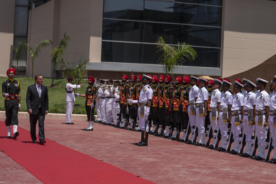 German Defense Minister Boris Pistorius inspects a joint military guard of honor upon his arrival for a meeting with Indian Defense Minister Rajnath Singh in New Delhi, India, Tuesday, June 6, 2023. (AP Photo/Altaf Qadri)