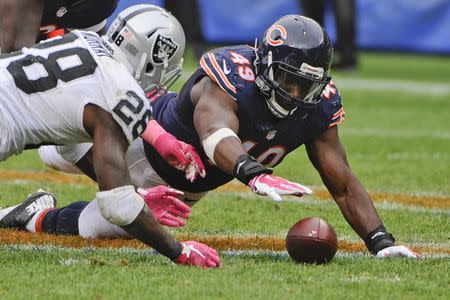 Oct 4, 2015; Chicago, IL, USA; Oakland Raiders running back Latavius Murray (28) loses a fumble that is recovered by Chicago Bears defensive end Sam Acho (49) in the second half at Soldier Field. Mandatory Credit: Matt Marton-USA TODAY Sports