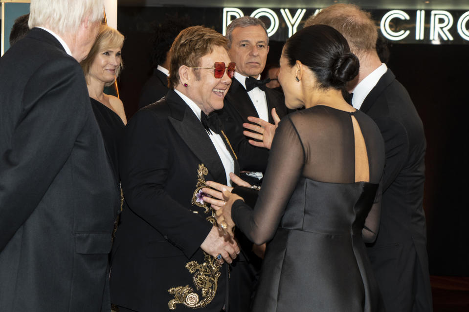 TOPSHOT - Britain's Prince Harry, Duke of Sussex (R) and Britain's Meghan, Duchess of Sussex (2nd R) chat with British singer-songwriter Elton John (C) as they arrive to attend the European premiere of the film The Lion King in London on July 14, 2019. (Photo by Niklas HALLE'N / POOL / AFP)        (Photo credit should read NIKLAS HALLE'N/AFP/Getty Images)