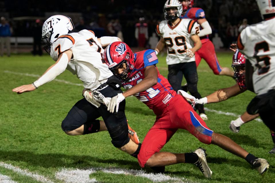 Neshaminy junior Demacio Cooper brings down Pennsbury junior Nate Beighley during the Falcons' 35-0 win Friday night.