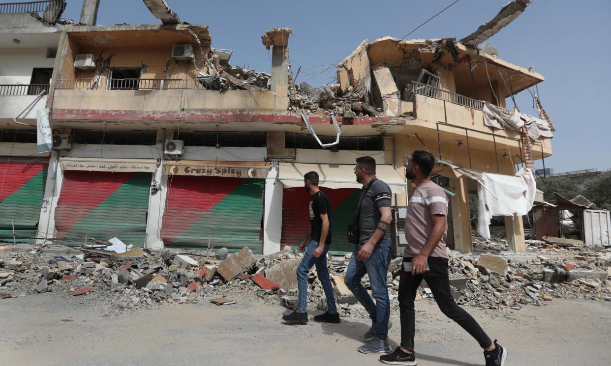 <span>Lebanese villagers pass a building in Kfar Kila destroyed by Israeli shelling, April 2024.</span><span>Photograph: Mohammad Zaatari/AP</span>