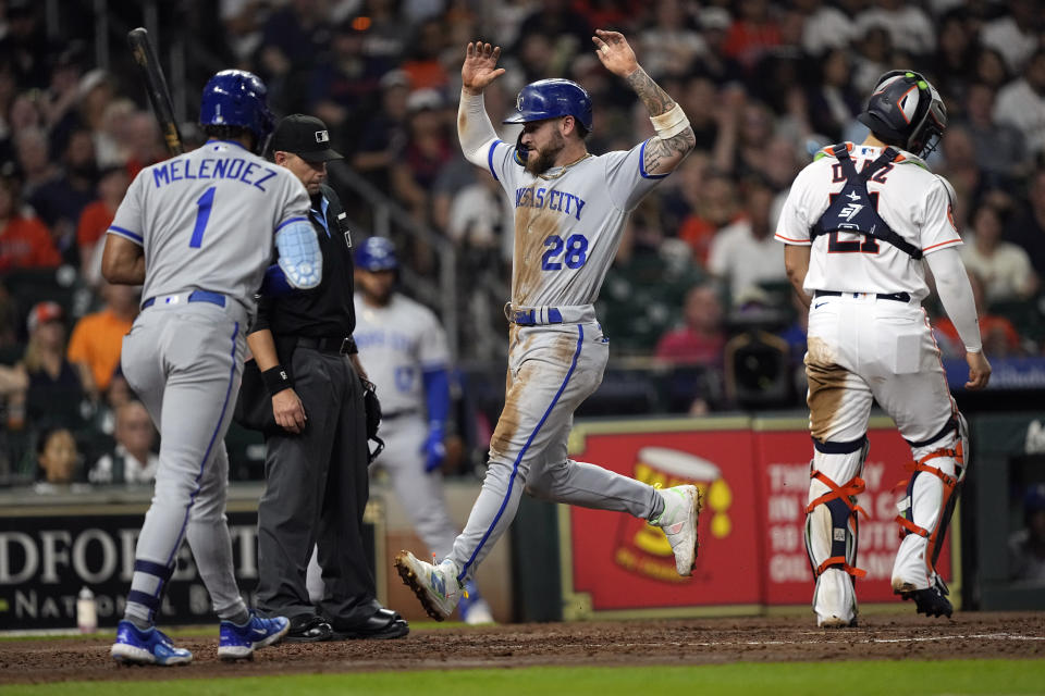 Kansas City Royals' Kyle Isbel (28) scores on a wild pitch thrown by Houston Astros starting pitcher J.P. France as catcher Yainer Diaz (21) stands at home plate during the fifth inning of a baseball game Saturday, Sept. 23, 2023, in Houston. (AP Photo/David J. Phillip)