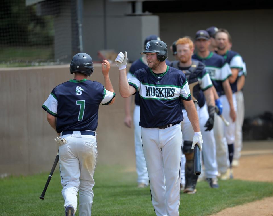 The Sartell dugout celebrates one of the runs as the Sartell Muskies host the Sauk Rapids Cyclones at St. Cloud Orthopedics Field on Saturday, July 16, 2022.