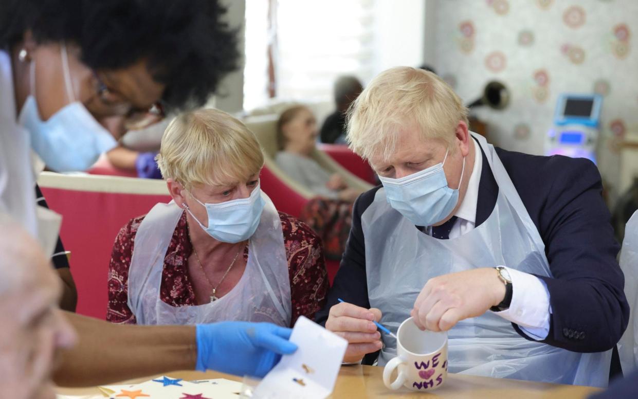 Prime Minister Boris Johnson visiting a care home earlier this year - Universal News & Sport